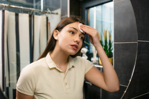 istock Beautiful young Caucasian woman taking her makeup off 1295361832
