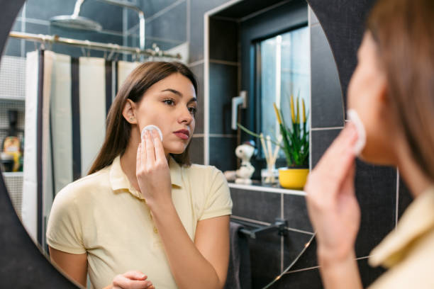 istock Beautiful young Caucasian woman taking her makeup off 1295362044