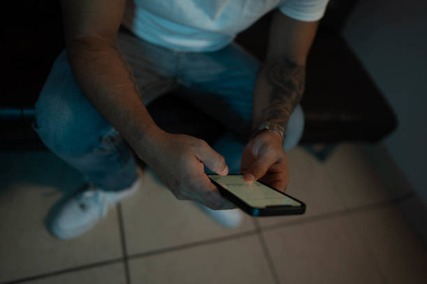 Unrecognizable man looking at his cellphone