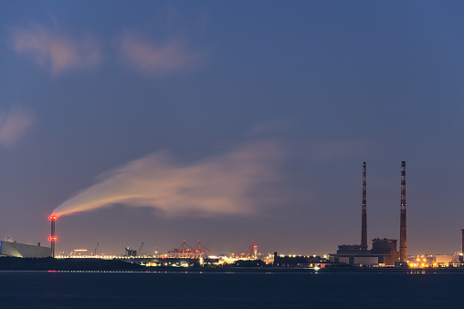 Dublin Waste to Energy (Covanta Plant), Poolbeg CCGT and Pigeon House Power Station view from Seapoint Beach during the blue hour, Dublin, Ireland