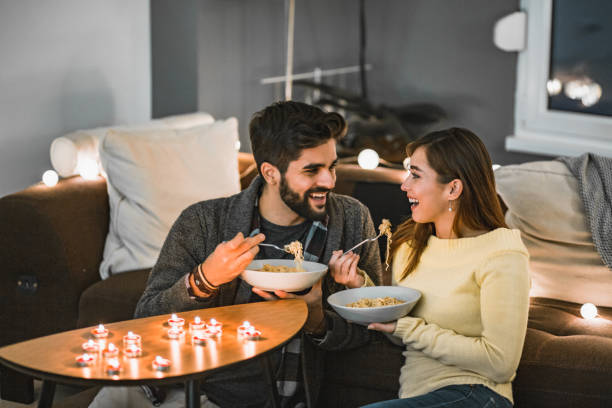 Romantic and easy dinner at home A young couple is at home, they are enjoying their free time and eating dinner romantic activity stock pictures, royalty-free photos & images