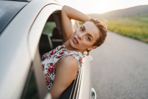 istock Leaning out the window of car 1295377102