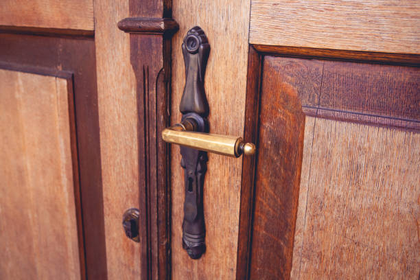 Close up view of a stylish brass handle on a brown vintage door