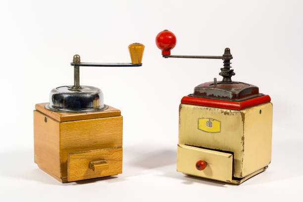 istock Old wooden colored manual coffee grinders on white background, with copy space 1295378914