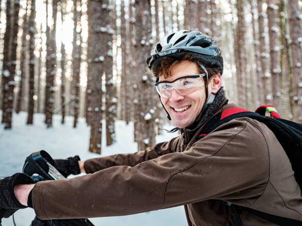 istock Adult man riding fat bicycle in winter 1295379846