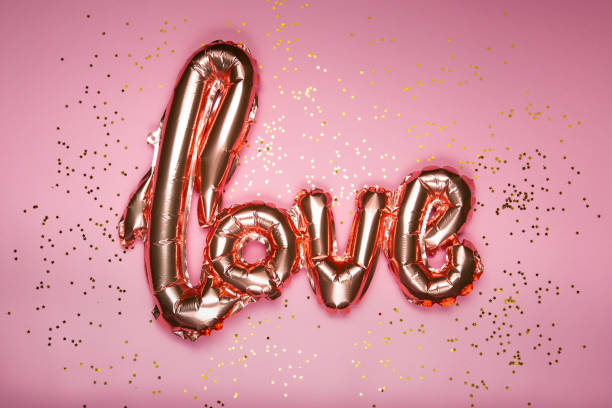 istock golden word love on pink background 1295380244