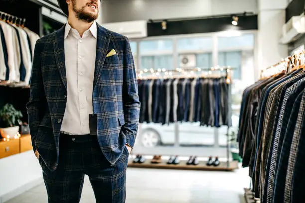 Businessman trying suit in store