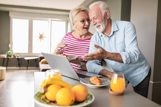 istock Senior couple using laptop at home 1295385573