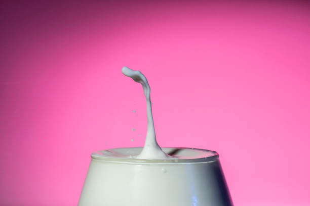 istock Drop of frozen milk falling and making splash. 1295387069