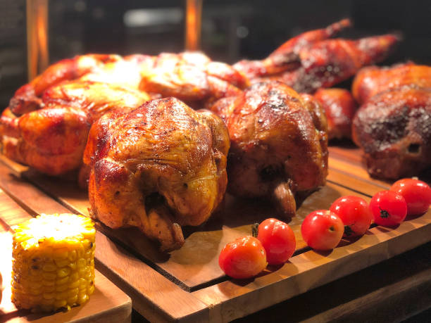 istock Roasted chicken with tomato and corn on wooden table 1295391198