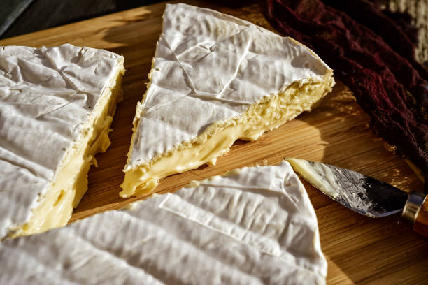 istock wedge of brie cheese cut from whole round 1295391242