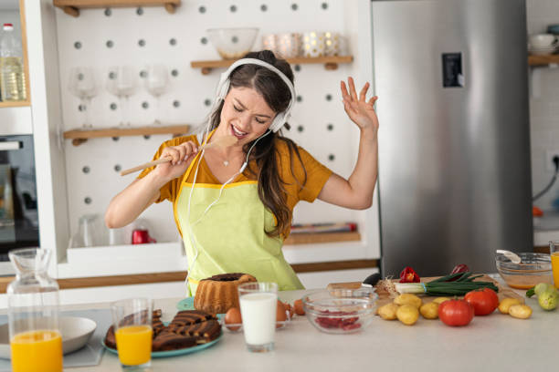 istock Young woman having fun in the kitchen 1295392838