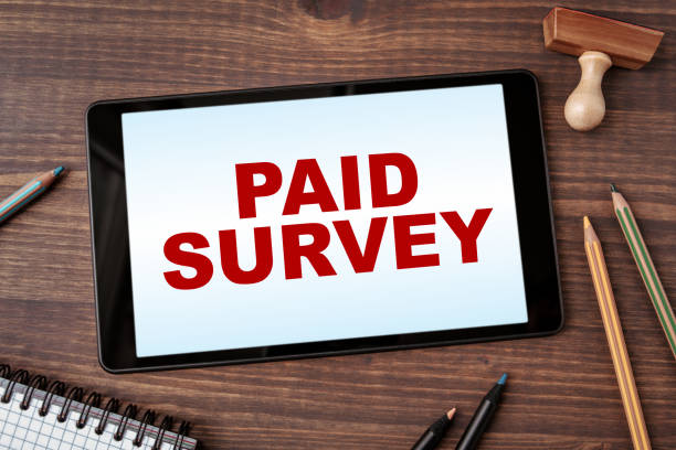 istock Paid Survey. Business concept. Tablet computer on a wooden office desk 1295393744