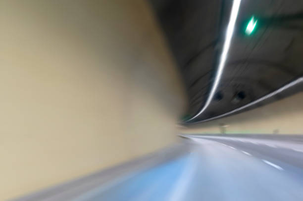 istock road tunnel blurred motion with curve driver perspective vanishing point 1295397534