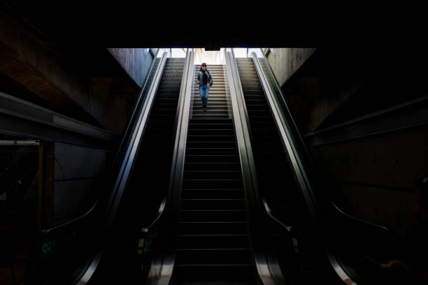 istock Woman alone walking down stairs 1295402702