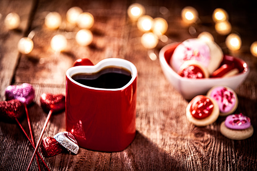 Valentines Day Coffee and Lighting Decorations on Retro Wood Background