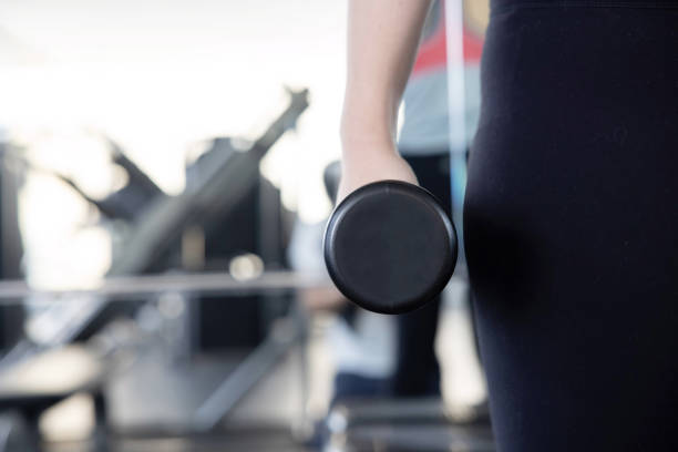 Close-Up on Woman Hand Holding Dumbbell for her Exercise