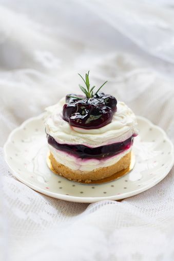 no baked blueberry layered cheesecake, ombre mousse cake, decorated with fresh berries and edible viola flowers