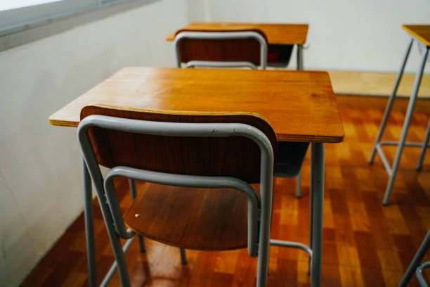 istock Empty classroom and desks preparation in primary school building in Asia. Elementary school interior 1295413482
