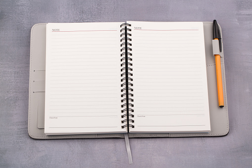 2021 schedule book and pen on gray background