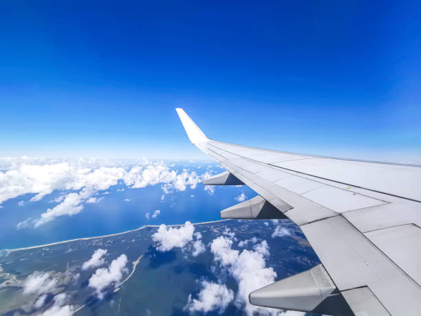 istock View of clouds, ocean, horizon and blue sky from airplane window 1295421065
