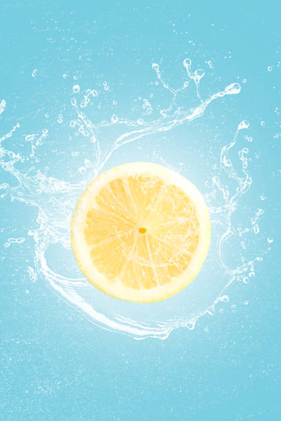 istock Lemon slice with water splash isolated on blue blackground. 1295421171