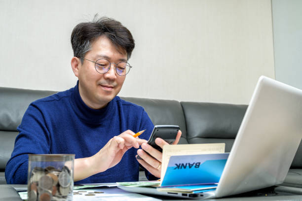 istock Middle-aged Asian man preparing for tax return. 1295423576