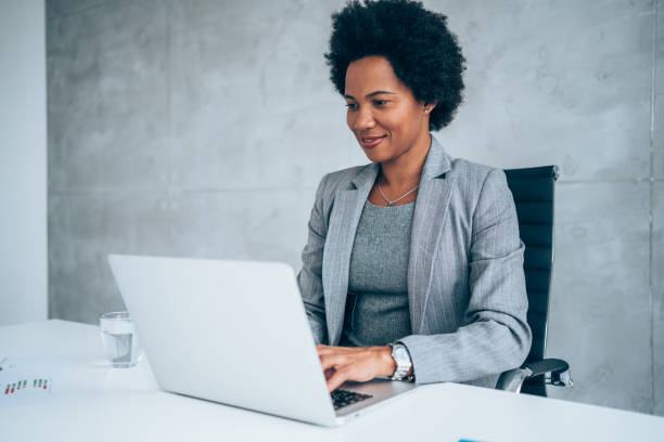 istock Successful businesswoman in modern office working on laptop. 1295425465