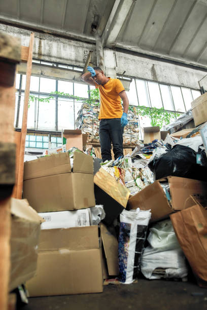 istock Young tired man standing on waste paper large pile 1295427410