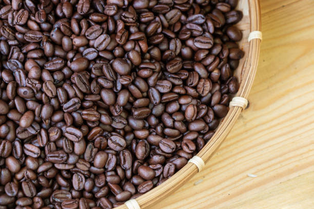 istock Roasted coffee beans on wooden background from top view. 1295427566