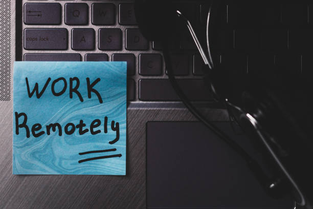 istock inscription work remotely laptop and headphones close up 1295428538