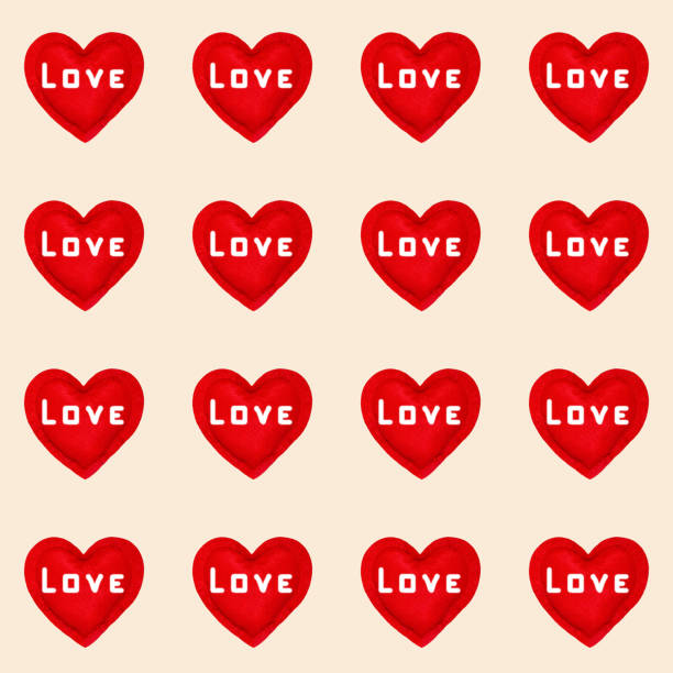 istock Pattern of red hearts with the word love on a pastel background for packaging 1295429918