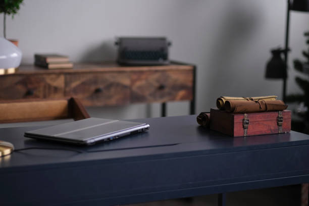 istock stylish home office details. closed laptop desktop, printable typewriter vintage background 1295431016