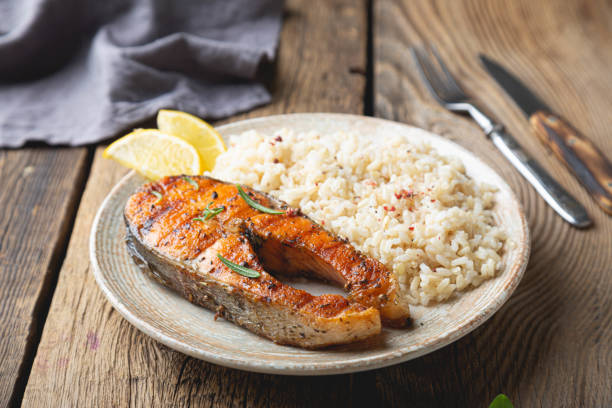 istock Grilled salmon and brown rice 1295434148