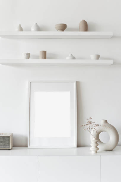 istock Blank picture frame mockup on white wall. Living room design 1295435757