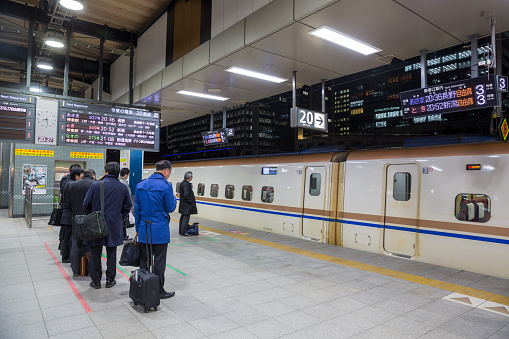 Commuters waiting the trains at Tokyo Station, Japan.  Shinkansen is Japan's high speed train (bullet trains) operated by Japan Railways.