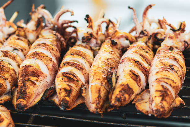istock Squids making on grill in Thailand market 1295439050