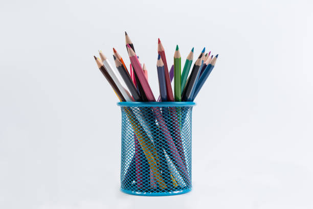 istock Colorful pencils in blue holder isolated on white background 1295440113