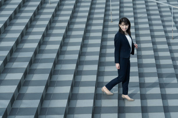 istock Woman walking on the stairs 1295442378