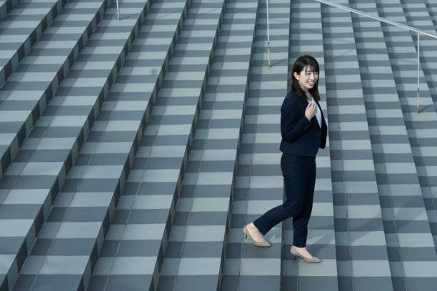 istock Woman walking on the stairs 1295442389