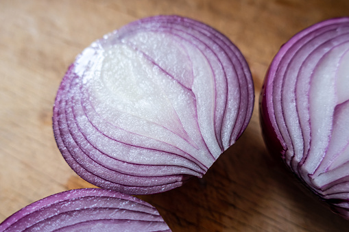 Purple onion on wooden board