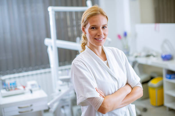 Attractive female dentist posing in the modern dental office