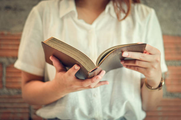 istock A young Christian woman closes her scriptures reading and studying in her room on Sunday. 1295446077