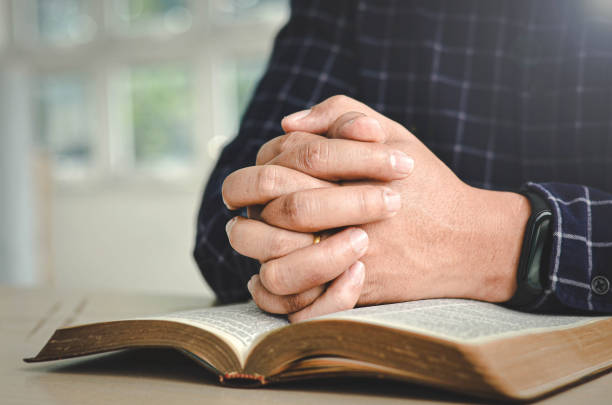 istock A man is praying to God through his words. 1295446133