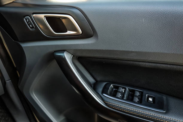 istock Car arm rest with Control Panel. Door Lock & Mirror Control. window adjustment buttons, door lock. Photography of a modern car. 1295446489
