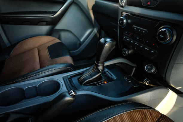 istock automatic transmission shift selector in the car interior. Closeup a manual shift of modern car gear shifter. 1295446491