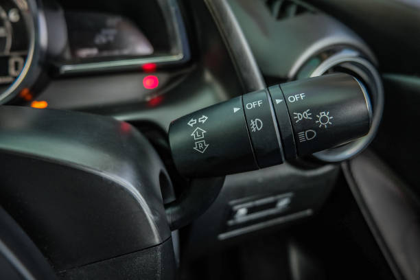 Switch off lights in a car. close-up Car integrated turning indicator with headlight switch toggle.