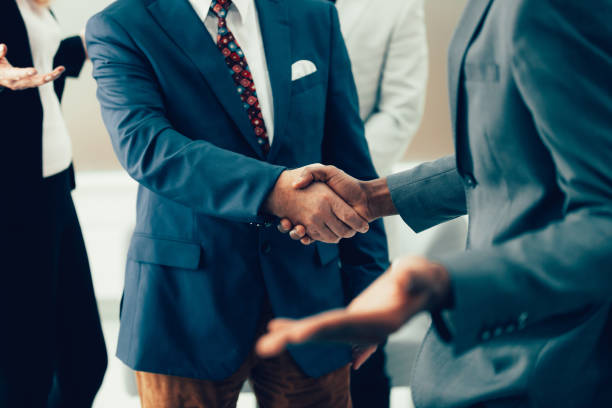 istock young entrepreneurs shaking hands in the office 1295446526