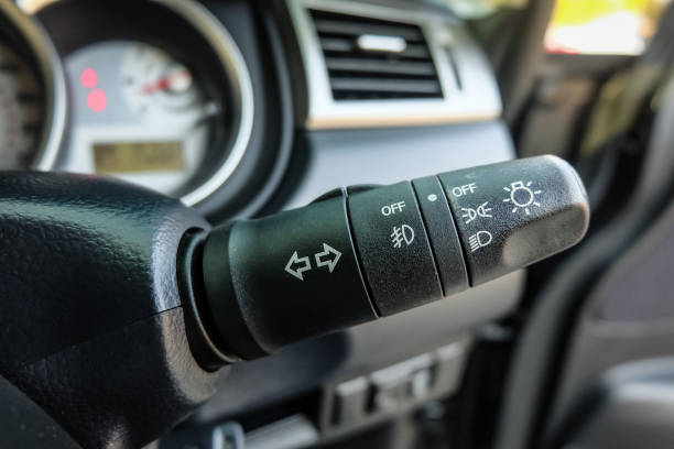 istock Switch off lights in a car. close-up Car integrated turning indicator with headlight switch toggle. 1295446552