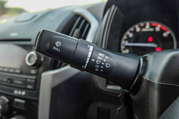 istock Windscreen wiper control switch in car. Wipers control. Modern car interior detail. adjusting speed of screen wipers in car. 1295446555